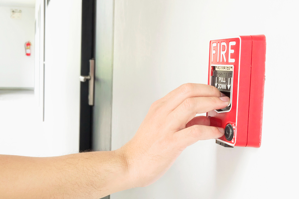 Fire safety expert inspecting emergency lights in a retail store during a Fire Risk Assessment.