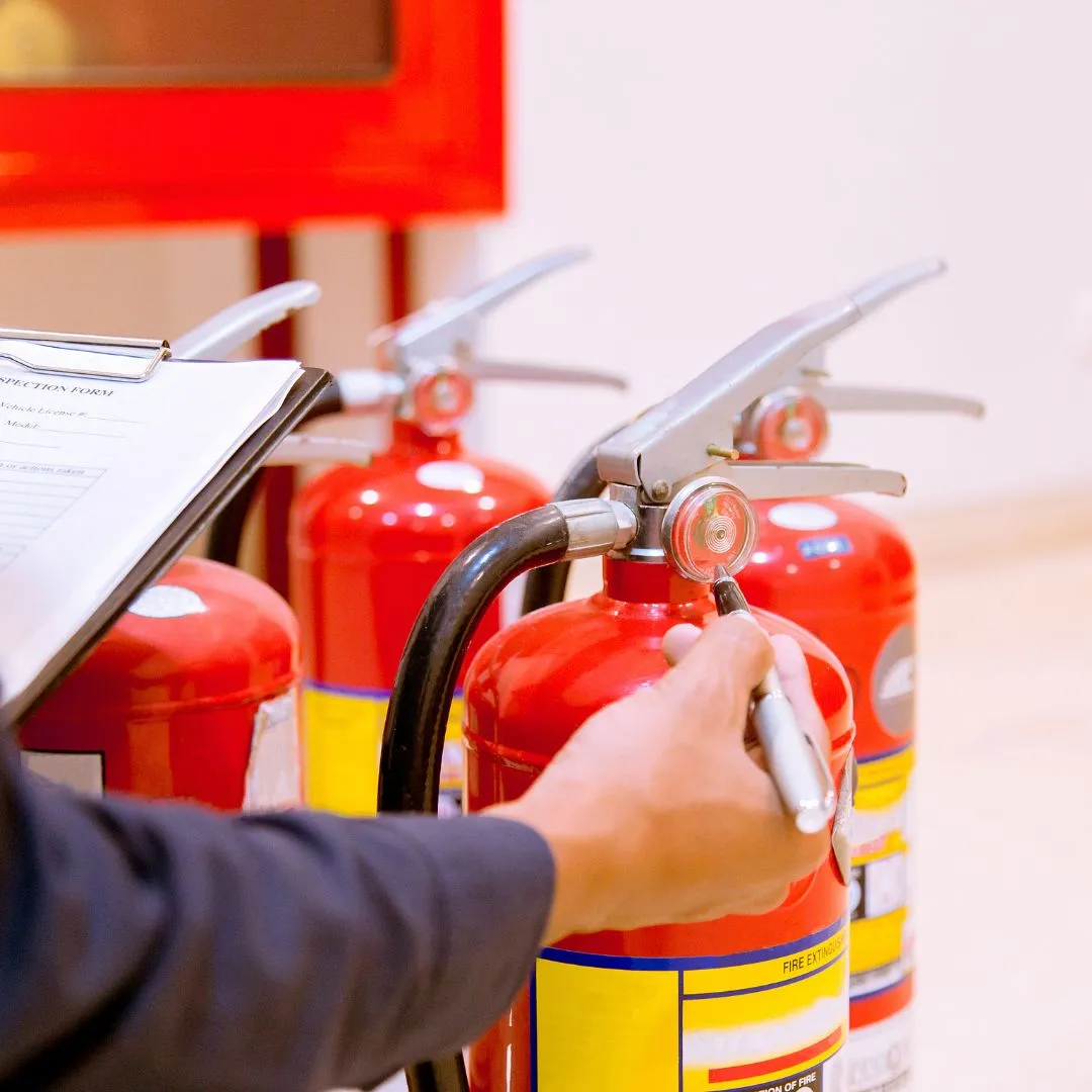 Inspector conducting a fire safety audit with focus on safety equipment.